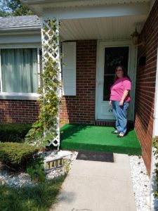 Sarah standing at front door