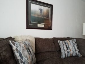 couch with eagle picture over it